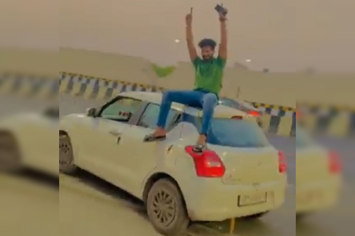 young-man-dancing-on-the-roof-of-the-car-video-viral.jpg