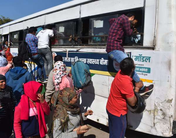 crowd of examinees at the bus stand and railway station