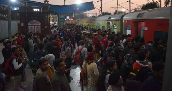 crowd of examinees at the bus stand and railway station