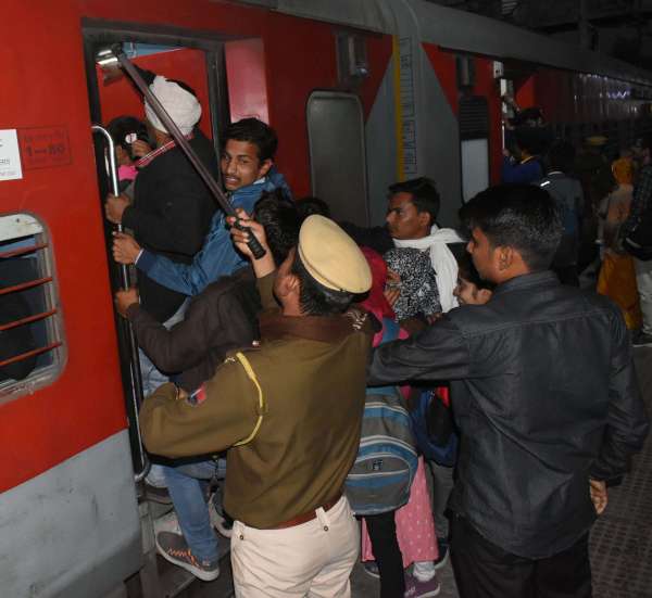 crowd of examinees at the bus stand and railway station