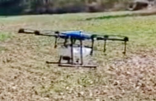 रिमोट कंट्रोल से ऑपरेट होता ड्रोन छिड़काव करता हुआ।