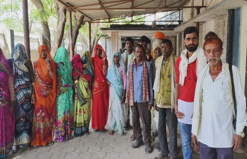 Laborers in paper, work being done by machines on the spot