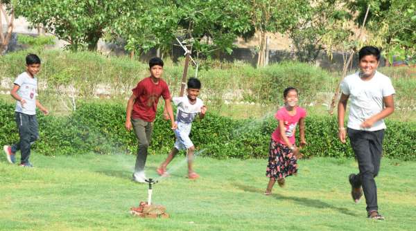 children playing in the water in summer