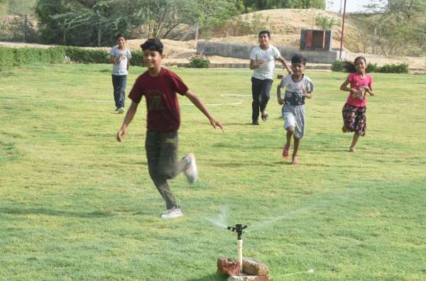 children playing in the water in summer