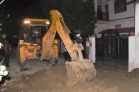 Two workers fell into a pit 10 feet below due to mudslide