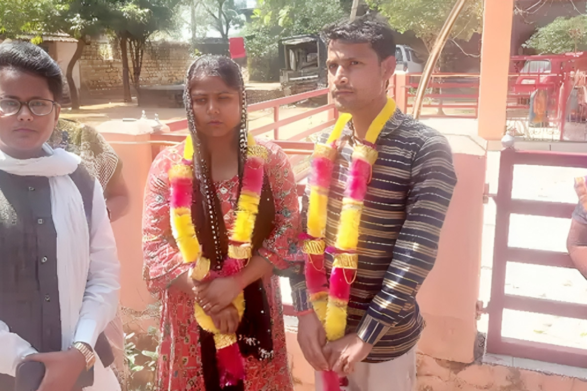 bride and groom standing in police station wearing garlands