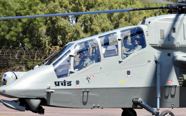 Defence Minsiter Rajnath Singh takes sortie in the first indigenously developed Light Combat Helicopter (LCH) ‘Prachand’ during its induction into Indian Air Force, at Jodhpur airbase 