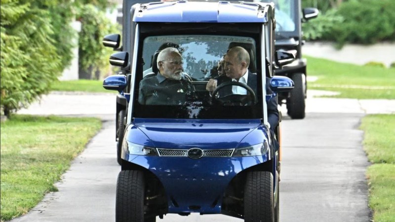 Russian President Vladimir Putin drives Indian PM Narendra Modi in golf cart