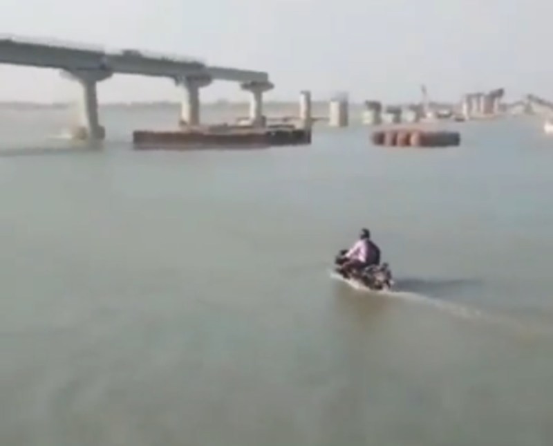 Bike rider rides motorcycle on water