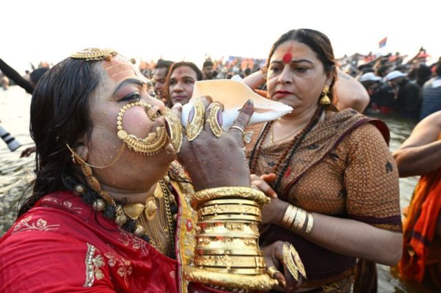 Kinnar Akhada Mahamandaleshwar blowing a conch shell