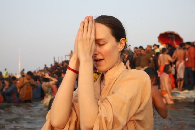 Foreign devotees taking a dip in the Sangam