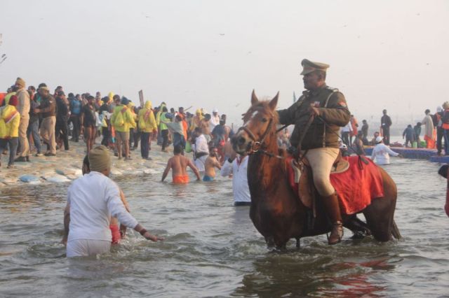 Police clearing devotees from the Sangam