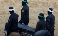 Hamas terrorists carrying hostage body in coffin