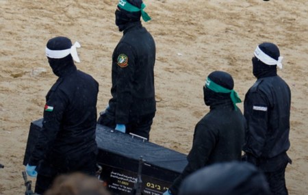 Hamas terrorists carrying hostage body in coffin