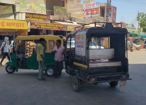 Traffic policemen resting in the shade and traffic rules being broken in the city