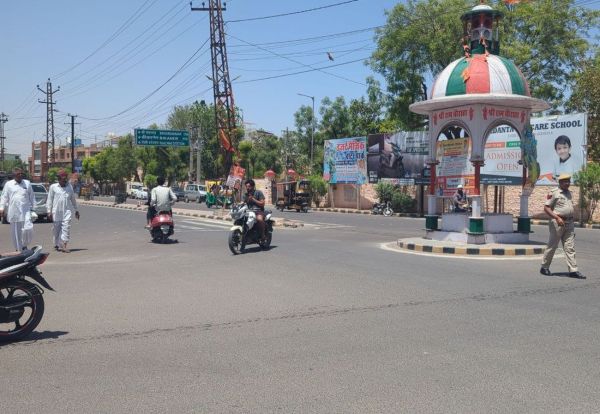 Traffic policemen resting in the shade and traffic rules being broken in the city