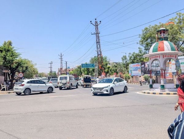 Traffic policemen resting in the shade and traffic rules being broken in the city