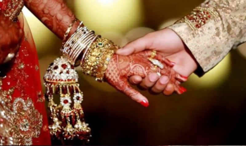 bride and groom spit on each other after taking water in their mouths