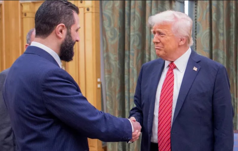 Donald Trump shakes hand with Ahmed al-Sharaa