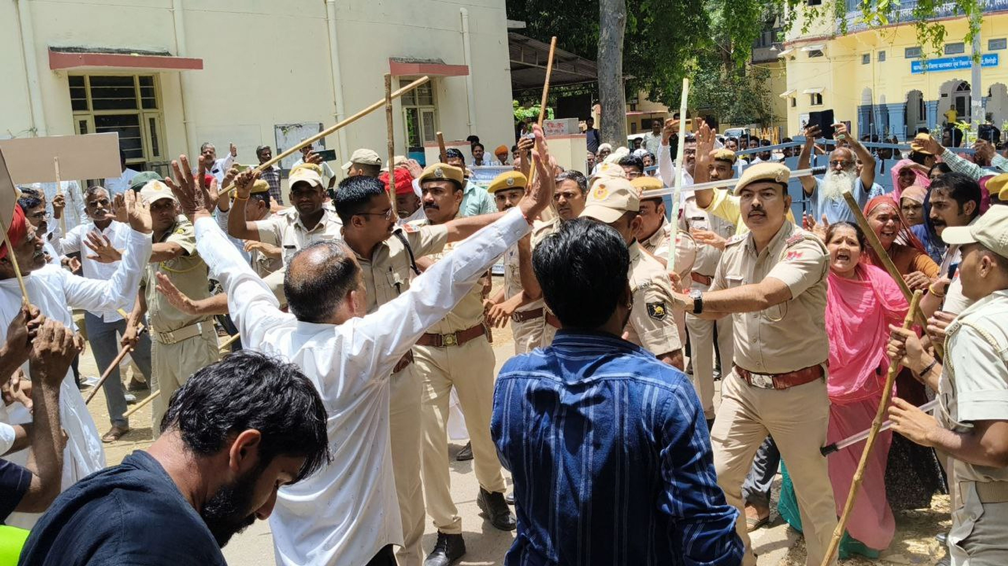 कलक्ट्रेट गेट पर बैठे लोगों को हटाती पुलिस।
