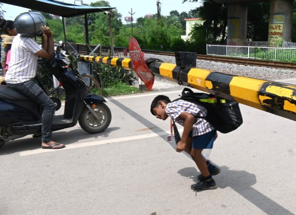 रेलवे फाटक पर खतरे का खेल, ट्रेन आने की चेतावनी को अनदेखा कर रहे लोग, देखें तस्वीरें 
