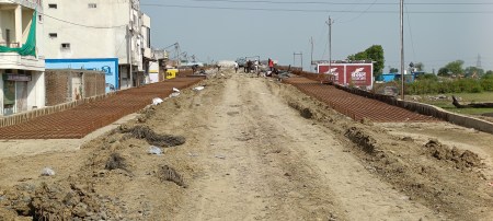 The administration is unable to provide land to complete the construction of the incomplete bridge, causing distress to thousands of people.