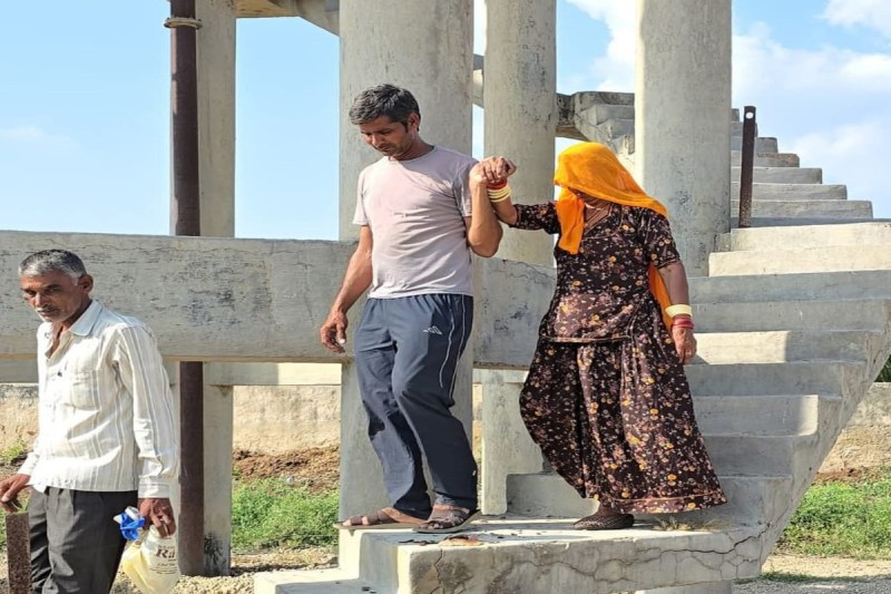 elderly woman climbed on water tank