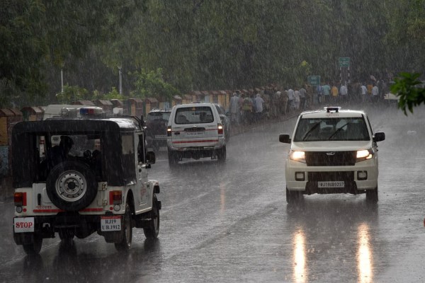 Rajasthan rain alert, Jaipur heavy rainfall, IMD weather update, vehicles on wet road during rain