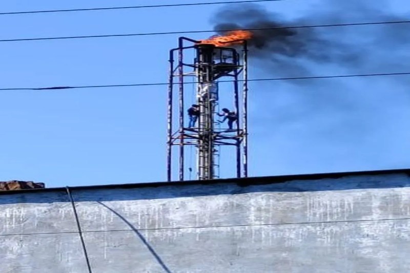 Toxic fumes became a menace for the villagers; two young men climbed a thirty-foot-tall chimney.