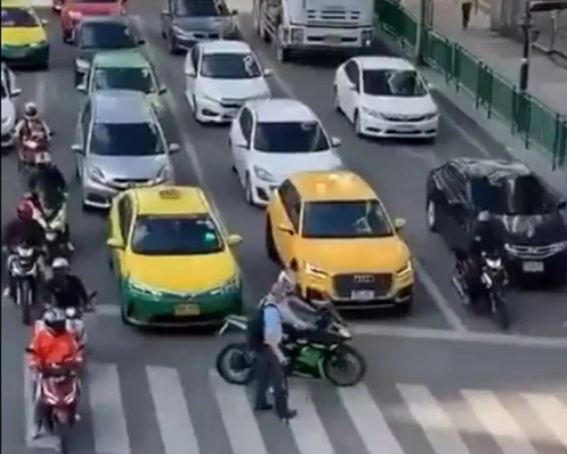 Bike rider helping an old man cross road