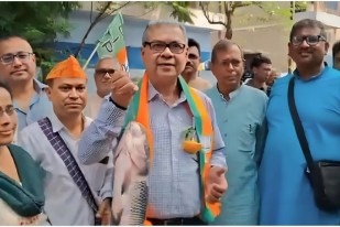 BJP leader campaigning holding a fish in his hand