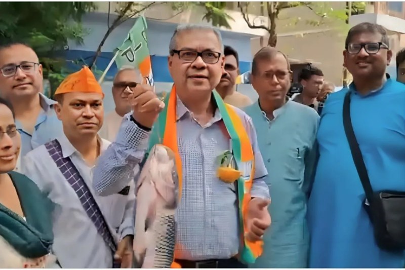 BJP leader campaigning holding a fish in his hand