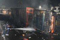 Bharatpur trailer fire accident, Agra Bikaner highway crash, Saras Chauraha accident, coal loaded trailer fire, driver burnt alive incident, Bharatpur road accident news, divider collision trailer, diesel spill fire accident, Mathura Gate police station area, Ajmer driver death case, late night highway accident, Rajasthan traffic disruption, fire brigade rescue operation, fatal highway crash India, police investigation ongoing