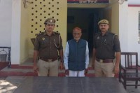 Two police officers with a person.