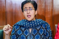 aap mps merger controversy atishi targets bjp and pm narendra modi
