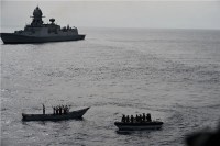 INS Kolkata and its helicopter intercepting suspected pirate activity near MV Mashallah 1.