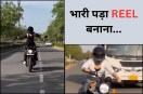 Girl performing Statue of Liberty pose on moving Bullet bike in Jaipur