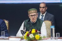 A political representation featuring Jammu and Kashmir Chief Minister Omar Abdullah and West Bengal Chief Minister Mamata Banerjee, highlighting debates over exit poll credibility, EVM security concerns, and strong room monitoring during elections amid a tense electoral atmosphere.