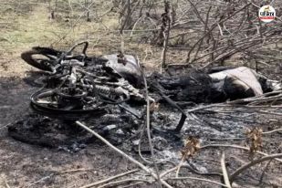Burnt motorcycle in a barren area