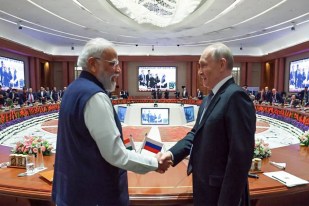 PM Modi and President Putin, Leaders of India and Russia shaking hands at a global summit.