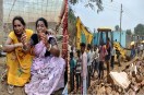 Women grieving amidst construction debris