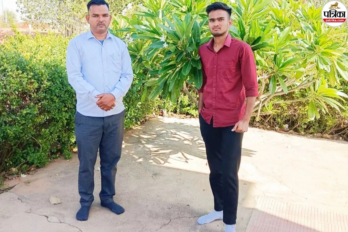 Two men standing outdoors, casual attire.