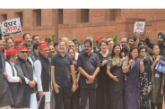 Opposition MPs protest in black clothes at Parliament.