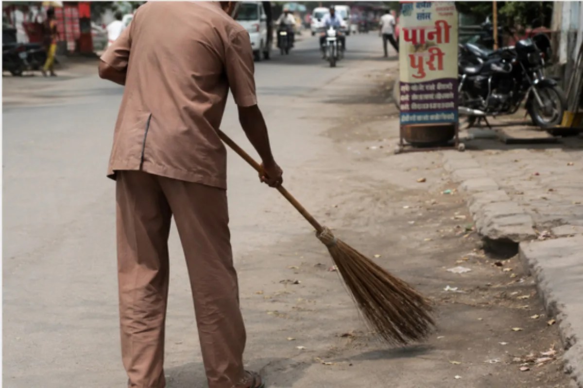 Old man sweeping