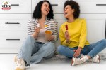 laughing together outdoors showing the positive impact of strong friendships on health