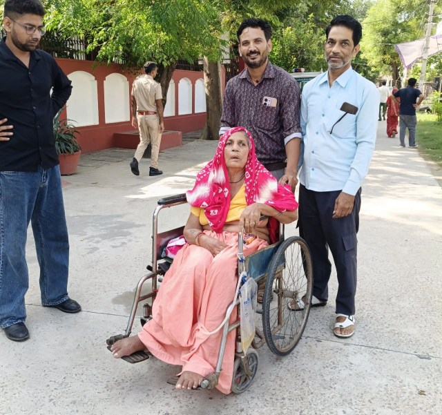 An elderly woman suffering from paralysis arrived to cast her vote