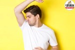 A person drying their underarms with a clean towel after a shower, representing body odor and skin hygiene