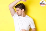 A person drying their underarms with a clean towel after a shower, representing body odor and skin hygiene
