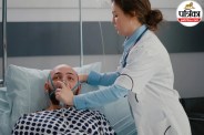Doctor checking patient on ventilator in ICU for brain death diagnosis
