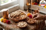 A bowl of mixed dry fruits including almonds, walnuts, and makhana placed on a wooden table